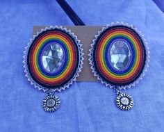 The most updated Inclusive Pride Flag! The edging is the Transgender Flag colors, all beads are Delicas and Tohos. There is also a silver sunflower charm hanging of each earring. Backing is deer hide and the center is a plastic oval gem. Bohemian Beaded Embroidered Earrings For Festivals, Bohemian Embellished Beaded Earrings, Inclusive Pride Flag, Hand Beaded Earrings, Embroidery Flats, Sunflower Charm, Ribbon Skirts, Beaded Earrings Patterns, Pink Beads