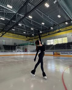 a woman skating on an indoor ice rink