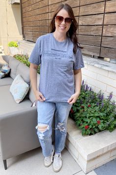 Downtown Plano Est. 1873! This cute heather grey top shows your love to Downtown Plano! Building shown are Coco Beach to Jett Petts Buildings! Hand Drawn details of Downtown Plano as they are in 2023! Top is round neckline and unisex sizes! Trendy Tops, Mom Style