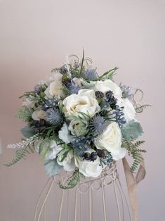 a white and blue bouquet in a wire basket