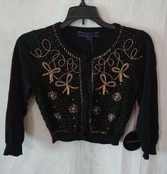 Women's/Junior's Vintage Black & Gold Embellished Forever 21 Cardigan.  Cardigan has gold bead work throughout the entire front as seen in photos. Size Small. New with tags. Shipping Cost: Shipping costs are based on package weight and buyer location and are calculated by USPS.  If the item ships with priority mail [speed/expedited shipping], it means it weighs more than 16 ounces [1 pound]. I do not make up the shipping costs. Please do not purchase an item and give a low rating for shipping co Embellished Fitted Cardigan For Party, Black Embellished Winter Cardigan, Embellished Black Cardigan For Winter, Black Embellished Cardigan For Winter, Black Embellished Cardigan For Party, Embellished Sweater For Spring Party, Fitted Cardigan For Festive Fall Occasions, Fitted Cardigan For Festive Fall Season, Fitted Fall Cardigan For Festive Occasions