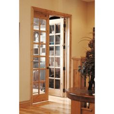 an open door leading to a living room with wood floors