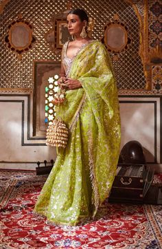 Editor's Note Neon Green Gota Patti Saree With Blouse Fabric: Silk Organza, Lampi Color: Green Care: Dry Clean Only About the Designer Itrh makes a high-end luxury Indian ethnic wear made using exquisite and endangered age-old crafts such as kalamkari, madhubani, chikankari, zardozi, and gota weaving. The focus of the house is to cherish the beauty of handcrafted luxury designer wear. Gota Patti Saree, Saree Floral, Green Saree, Blouse For Women, Indian Fashion Designers, Indian Fashion Dresses, Desi Fashion, Silk Organza, Indian Ethnic Wear