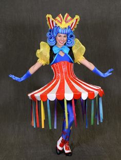 a woman dressed as a circus clown posing for the camera