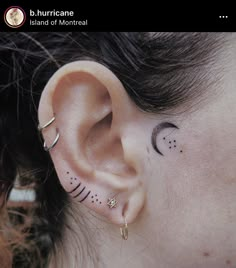 a woman's ear with small black dots and crescents on her left side