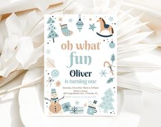 a white plate topped with paper snowflakes and christmas decorations next to an envelope that says oh what fun silver is turning one