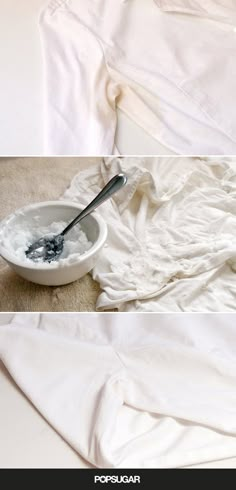 a white bowl filled with ice next to a spoon on top of a bed covered in blankets