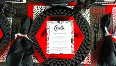 a red and black table setting with place settings