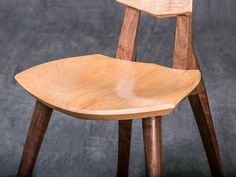 a wooden chair sitting on top of a gray floor