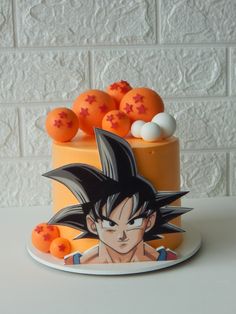 a birthday cake decorated with an image of gohan and oranges on it,