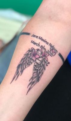 a woman's arm with an angel tattoo on it