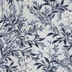 a blue and white floral wallpaper with lots of leaves on the top of it