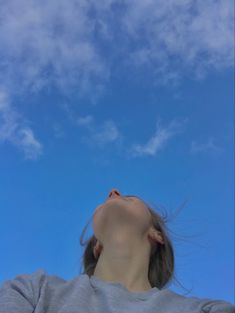 a woman looking up into the sky with her eyes closed