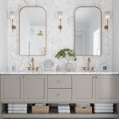 a bathroom with two sinks and three mirrors on the wall next to eachother