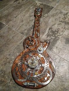 an intricately designed guitar sitting on the floor