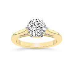 a yellow gold engagement ring with a round diamond in the center and side stones on each band