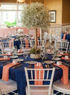 the tables are set with blue and orange linens