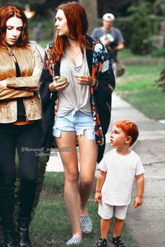 two women and a child walking down the street