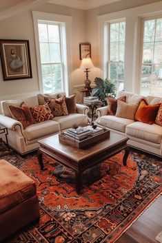 a living room with two couches, a coffee table and a rug on the floor