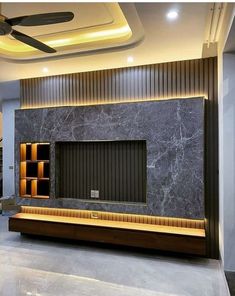 a modern living room with black and white marble walls, built in shelving unit