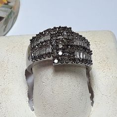 This 12mm Wide (Top Center) Offset Band Style Ring Features 3 Rows Of Round Chocolate Color Diamonds Coming Up From Each Side, 54) Chocolate Diamonds In All. There Is Also 2 Recessed Rows Of 26) White Diamond Baguettes Between Each Chocolate Row, And The Ring Is Aprox 1/2" Wide At The Very Top Center. The Ring Weighs Aprox 4.878 Grams Of Solid (Stamped 925 "Star" Gnd) Sterling Silver, And Has A Msrp Of $3595.00. Finger Size 6 3/4 (This Ring Can Be Sized By Your Local Jeweler, At Your Cost, We Do Silver Diamond Ring With Channel Set, Silver Diamond Ring With Channel Set Fine Jewelry, Silver Baguette Cut Diamond Ring For Anniversary, Silver Baguette Cut Diamond Ring With Prong Setting, Silver Diamond Ring With Baguette Cut And Prong Setting, Estate Rings, Chocolate Diamonds, Chocolate Color, Diamond Cross