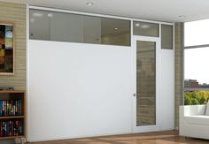 an empty room with white walls and glass doors, wood flooring and hard wood floors