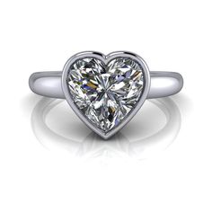 Solid Silver Solitaire ring shown with an 8mm, 2.00 ct. heart shape colorless simulated diamond. Band width 2.2mm tapered to 2mm.2.00 carat total weight. *Sterling Silver is Rhodium dipped to reduce tarnishing. Rhodium is a very strong metal that creates a protective layer over the sterling silver, making it more resistant to tarnishing.*Custom made at the time of order. Heart Shaped Engagement Rings, Simulated Diamond Rings, White Gold Set, Forever One Moissanite, Colorless Diamond, Ring Sizer, Boutique Design, Diamond Band, Custom Engagement Ring