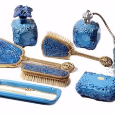 an assortment of blue and gold items including brush, comb, soap dispenser