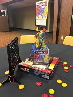 a table with game pieces on it and an object in the middle that says connect