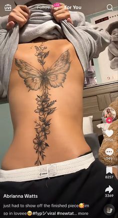 the back of a woman's stomach with flowers on it