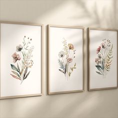 three floral paintings hanging on the wall