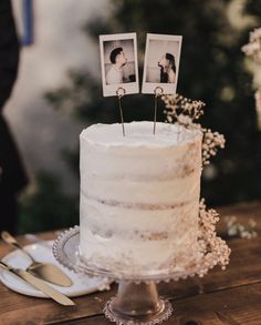 a wedding cake with two photos on top