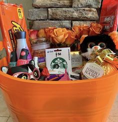 an orange bucket filled with lots of goodies