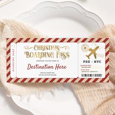 a christmas boarding pass sitting on top of a white plate