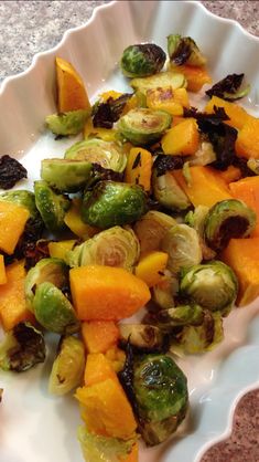 brussel sprouts and squash on a white plate