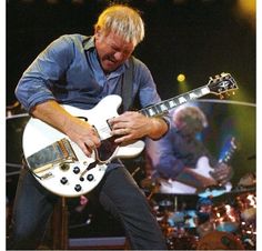 a man playing an electric guitar on stage