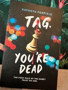 the book tag, you're dead by kathy foxfield is sitting on a table