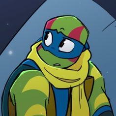 the teenaged ninja turtle is wearing a yellow scarf and blue hat with his eyes closed