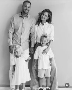 a family poses for a black and white photo