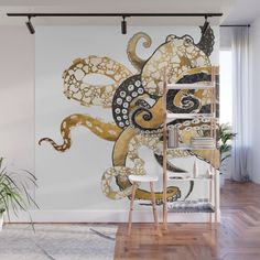 an octopus wall mural in a living room with white walls and wooden floors, along with two chairs