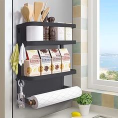 there is a shelf that has some items on it in front of a window with the ocean outside