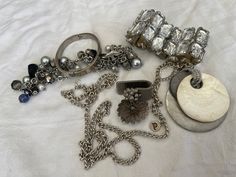 This is a 1/2 pound lot of broken and not, vintage and newer craft jewelry. The majority of these are wearable or for crafts, Silver tones There are necklaces, earrings, bracelets, key rings, broken pieces etc etc. Both vintage and modern. Perfect for your slow stitches or scrapbooking projects. Or other works of art This is NOT a mystery bag or box, so there will be no surprises You get everything in the picture. So study the pictures carefully Various materials such as plastic, metal, beads, etc etc Antique Metal Jewelry For Parties, Antique Metal Jewelry For Party, Vintage Bling Jewelry For Party, Costume Jewelry With Unique Variations For Parties, Party Costume Jewelry With Unique Variations, Vintage Metal Jewelry With Bling, Handmade Vintage Jewelry In Assorted Colors, Vintage Handmade Assorted Jewelry, Costume Jewelry For Accessorizing