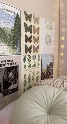 a bedroom with posters on the wall and a round ottoman in front of it's headboard