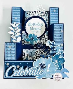 a blue and white birthday card with flowers