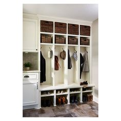 a white coat rack with baskets and coats hanging on it's sides in a kitchen