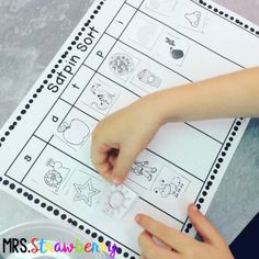 a young child is doing an activity with the words start and finish on their worksheet