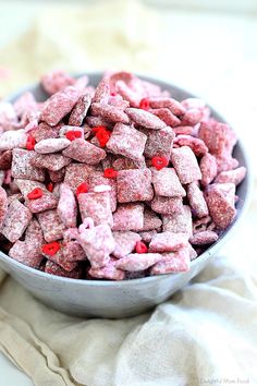 a bowl filled with pink dog treats on top of a table