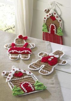 three crocheted gingerbread christmas ornaments on a table