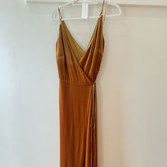 a dress hanging on a hanger in a room