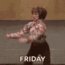 a woman is dancing in front of a brick wall with the words friday on it